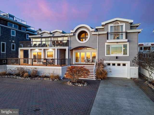 view of front facade with a balcony and a garage