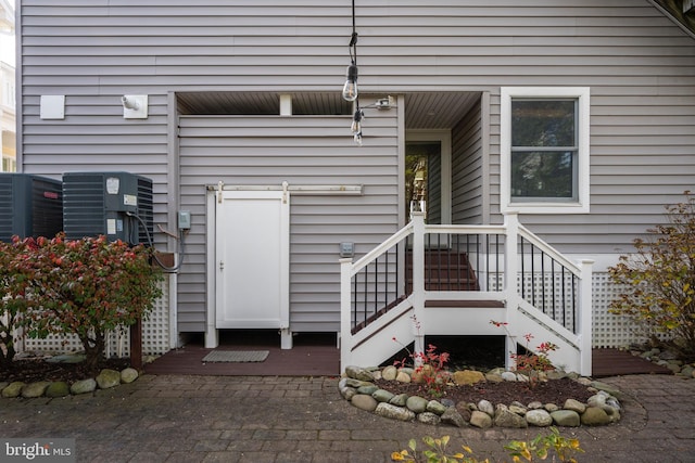 entrance to property featuring cooling unit