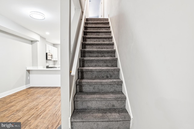 stairway featuring hardwood / wood-style floors