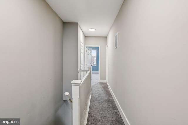 hallway featuring dark carpet