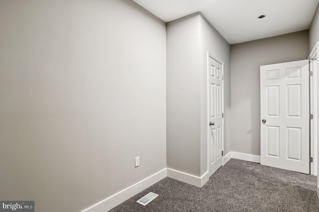 hallway with dark carpet