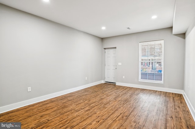 empty room with hardwood / wood-style flooring