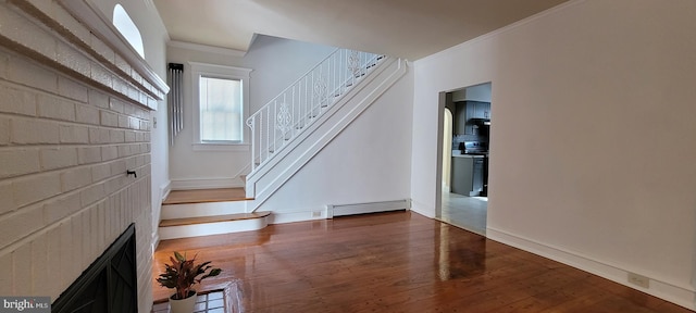 unfurnished living room featuring dark wood-type flooring, a baseboard radiator, and ornamental molding