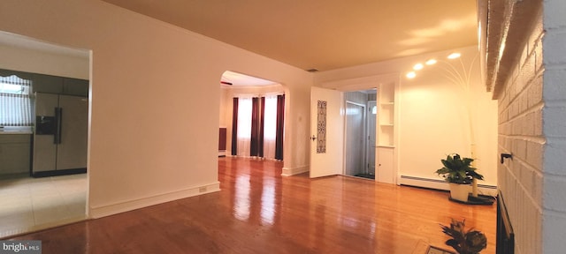 spare room featuring crown molding and hardwood / wood-style floors