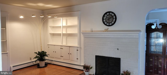 living room with a brick fireplace, wood-type flooring, a baseboard heating unit, and ornamental molding