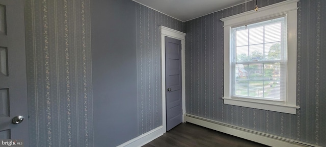 interior space with baseboard heating and dark wood-type flooring