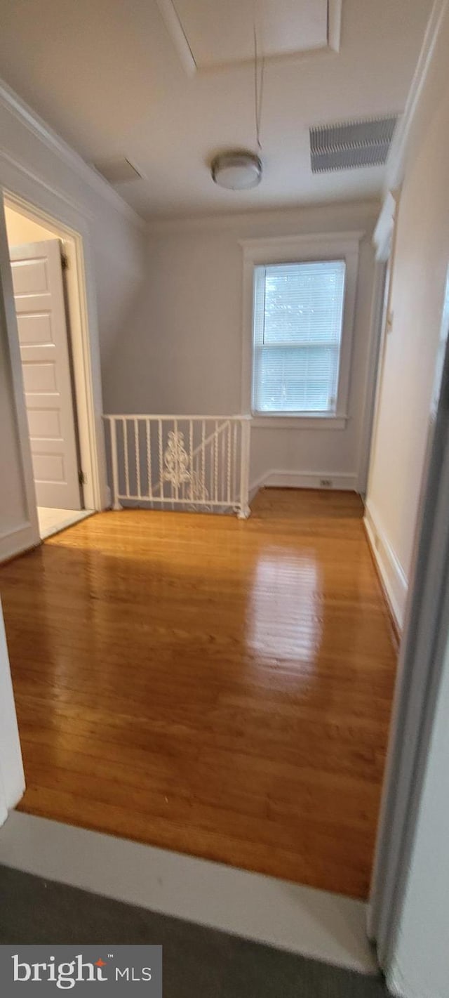 spare room with hardwood / wood-style flooring and ornamental molding