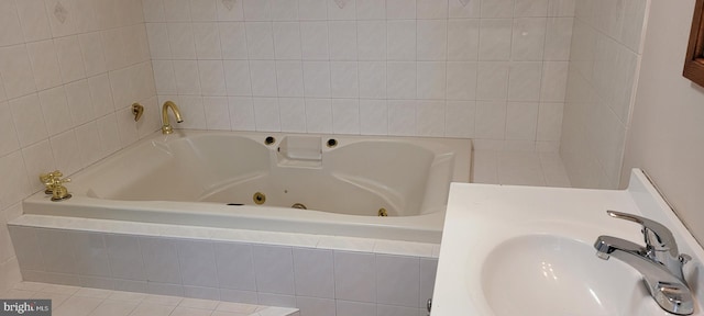 bathroom featuring a relaxing tiled tub and sink