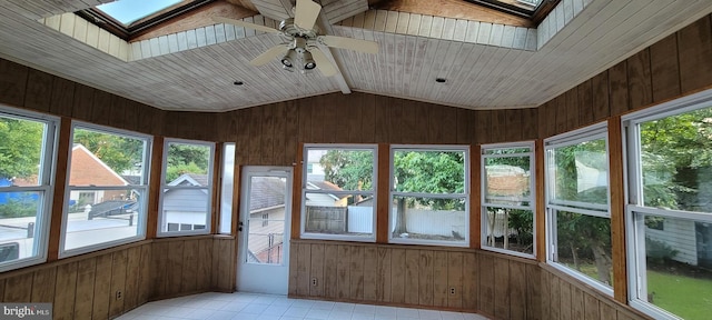 unfurnished sunroom featuring ceiling fan and vaulted ceiling with skylight