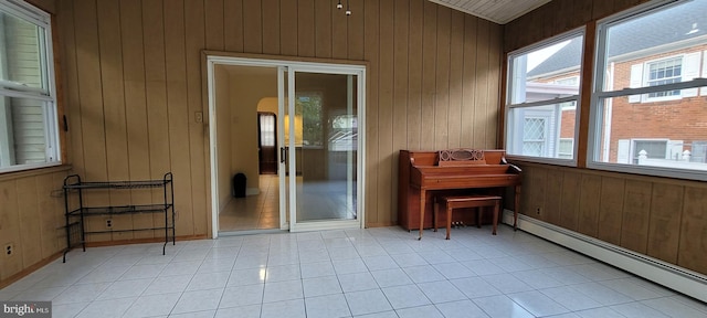 sunroom featuring a baseboard heating unit