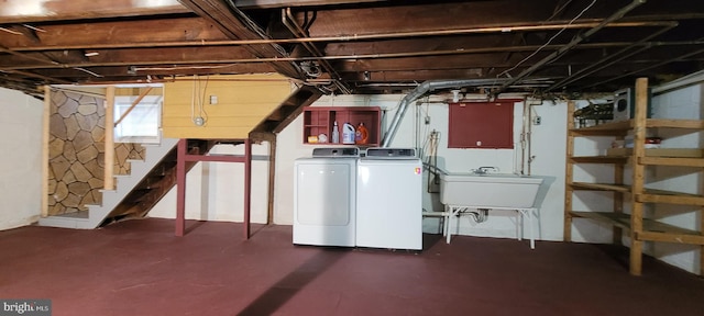 basement with washing machine and dryer and sink