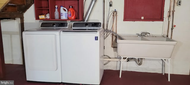 washroom featuring washing machine and dryer and sink