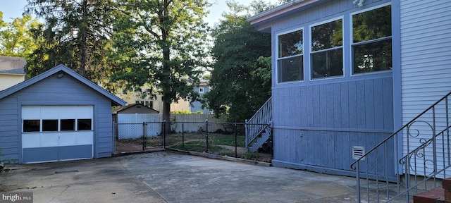 exterior space with an outbuilding and a garage