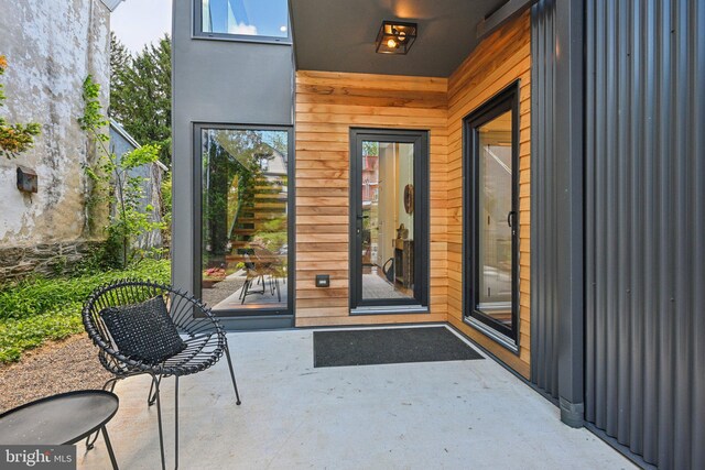 doorway to property with a patio area