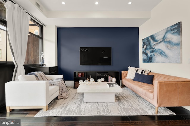 living area with visible vents, wood finished floors, and recessed lighting