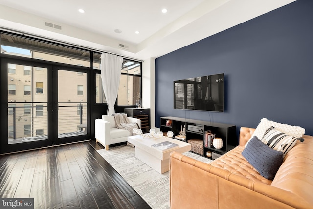 living room with visible vents, wood finished floors, and recessed lighting