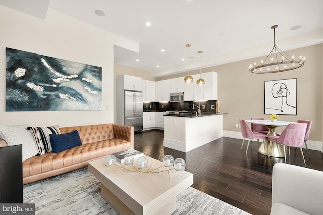 living room with recessed lighting, dark wood finished floors, and baseboards