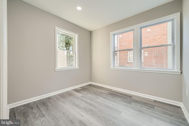 empty room with baseboards and wood finished floors