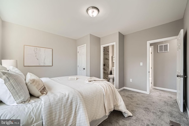 bedroom featuring carpet floors, ensuite bath, visible vents, and baseboards