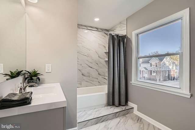 bathroom with double vanity, baseboards, marble finish floor, shower / bathtub combination with curtain, and a sink