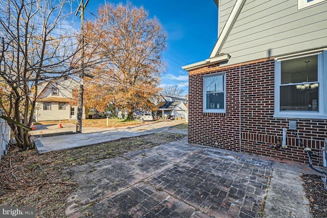 view of side of property featuring a patio area