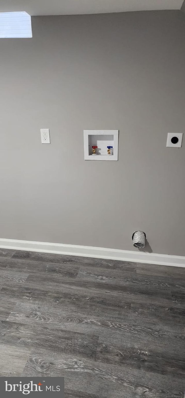 laundry area featuring washer hookup, laundry area, baseboards, and wood finished floors