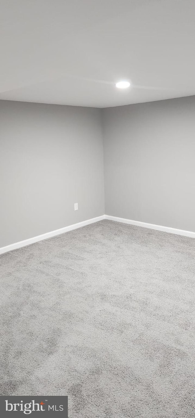 carpeted empty room with baseboards