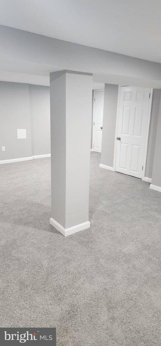 finished basement featuring carpet floors and baseboards