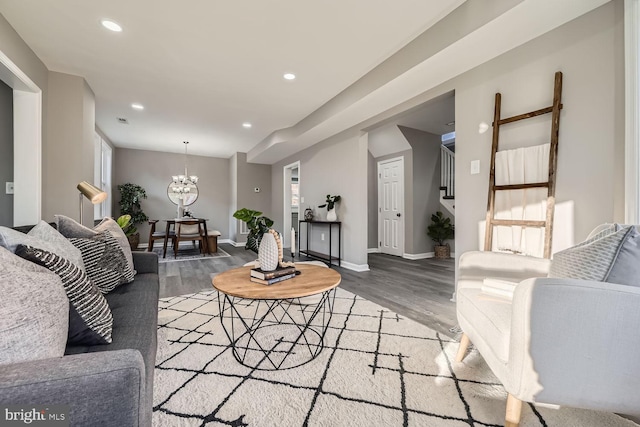 living room with a notable chandelier and hardwood / wood-style flooring