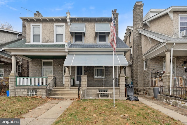 townhome / multi-family property featuring covered porch