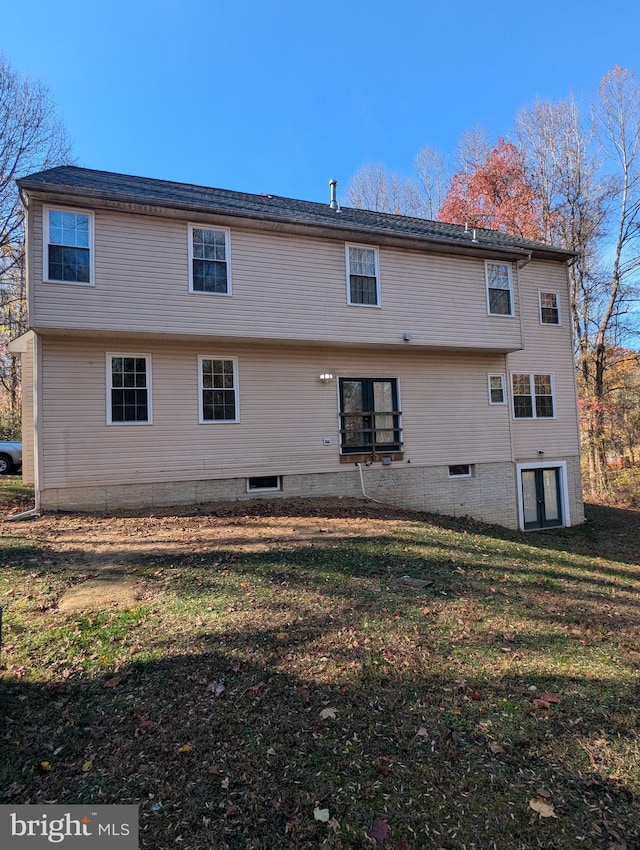 rear view of house with a yard