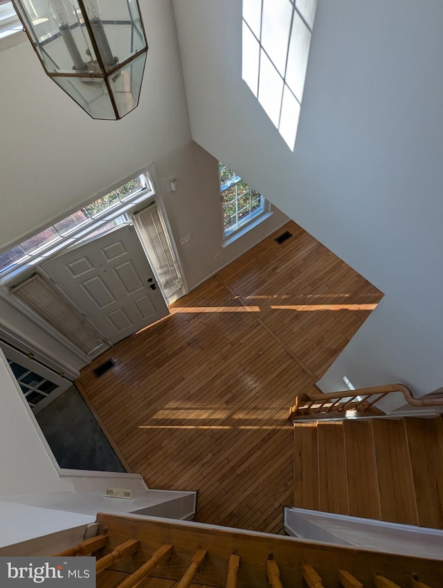 stairway with wood walls and a high ceiling