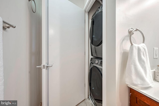 laundry room with stacked washer and clothes dryer