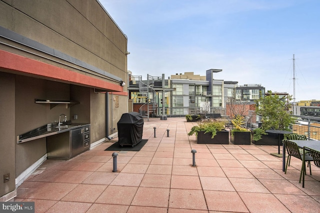 view of patio with area for grilling and sink