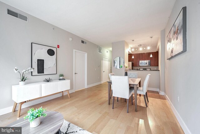 dining space with light hardwood / wood-style flooring