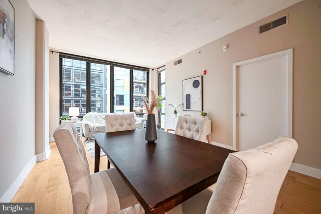 dining space with light hardwood / wood-style floors