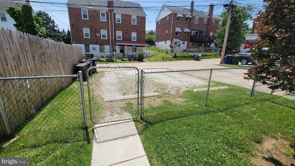 view of yard featuring a fenced front yard and a gate