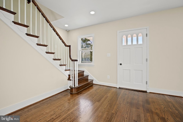 entrance foyer with recessed lighting, stairs, baseboards, and wood finished floors