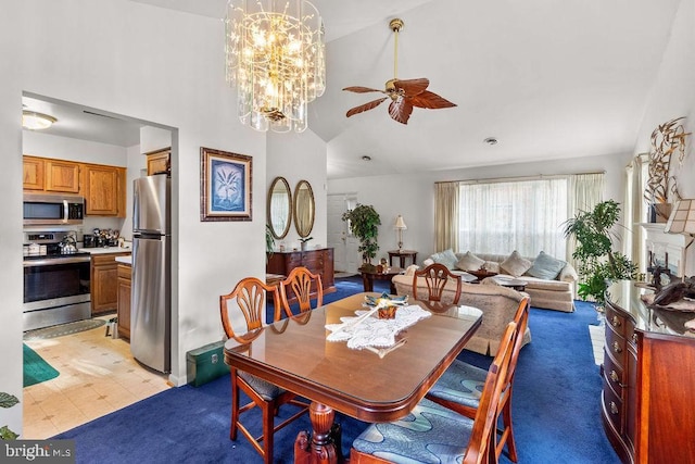 dining room featuring ceiling fan with notable chandelier and high vaulted ceiling