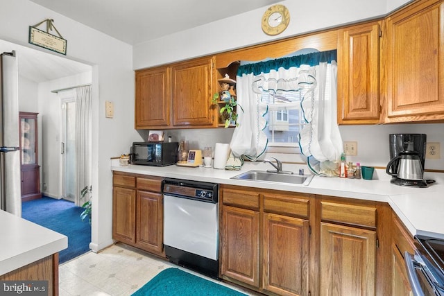 kitchen featuring white dishwasher, stainless steel range oven, and sink