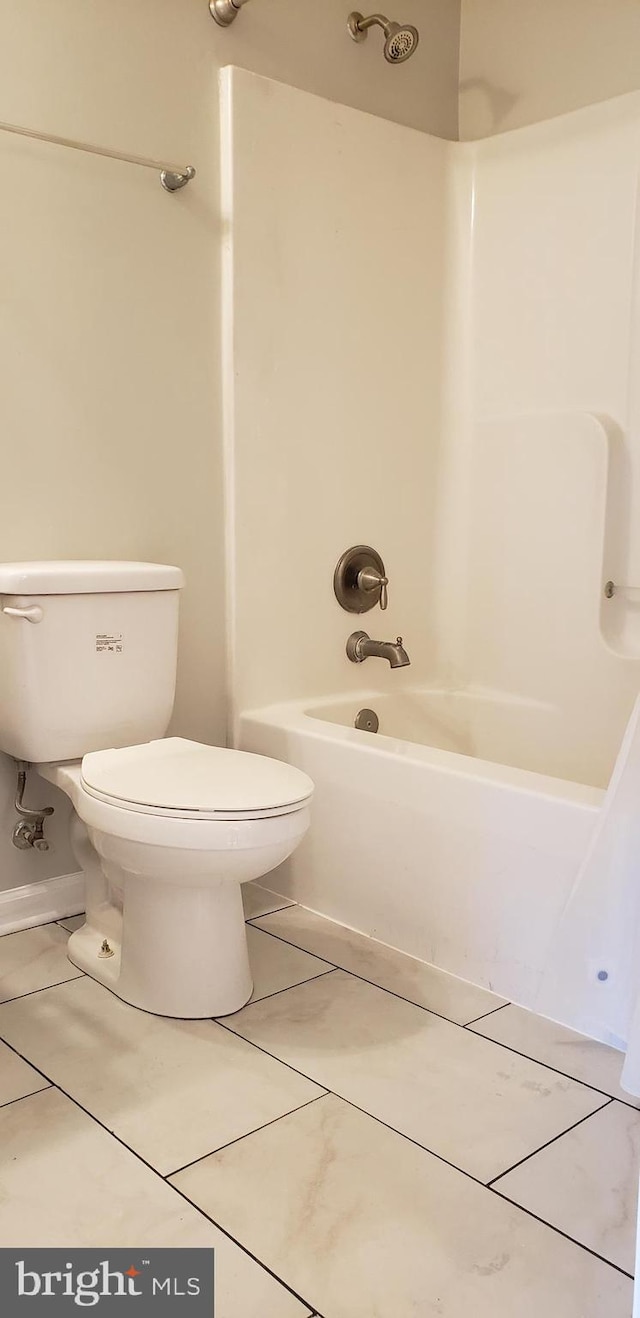 bathroom with tile patterned floors, shower / bath combo, and toilet