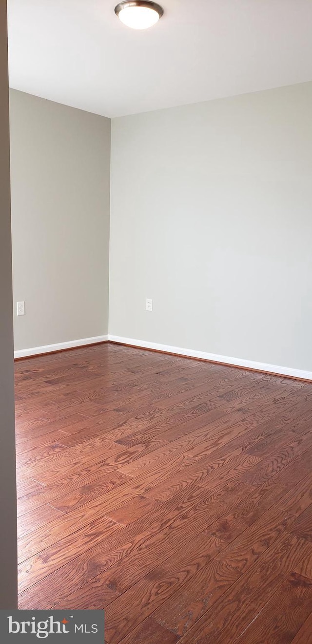 spare room featuring dark hardwood / wood-style flooring