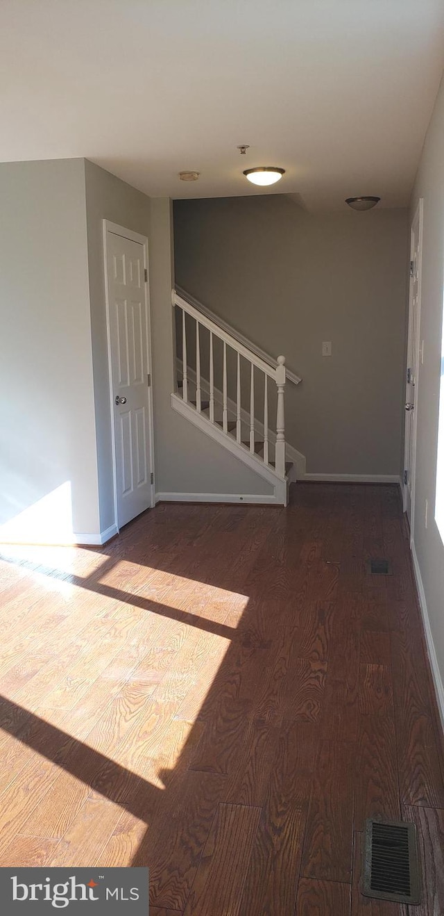 empty room with hardwood / wood-style floors