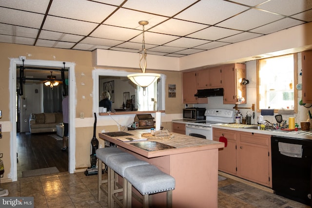 kitchen featuring white range, dishwasher, dark hardwood / wood-style floors, hanging light fixtures, and a breakfast bar area