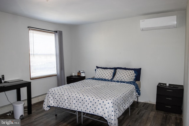 bedroom featuring dark hardwood / wood-style floors, a wall mounted AC, and a baseboard heating unit