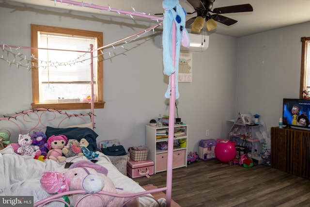 bedroom with a wall mounted air conditioner, ceiling fan, and dark wood-type flooring