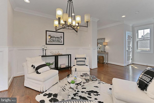 living room with ornamental molding, dark hardwood / wood-style floors, and a notable chandelier