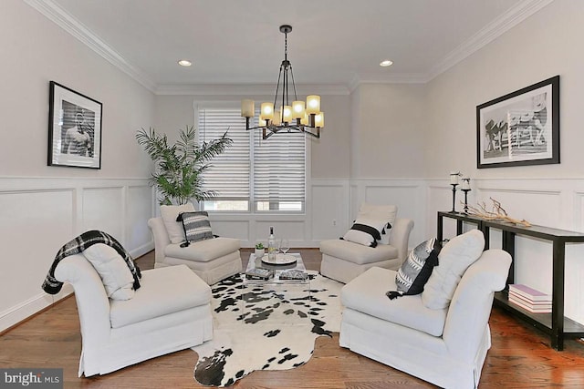 living room with a chandelier, crown molding, and wood-type flooring