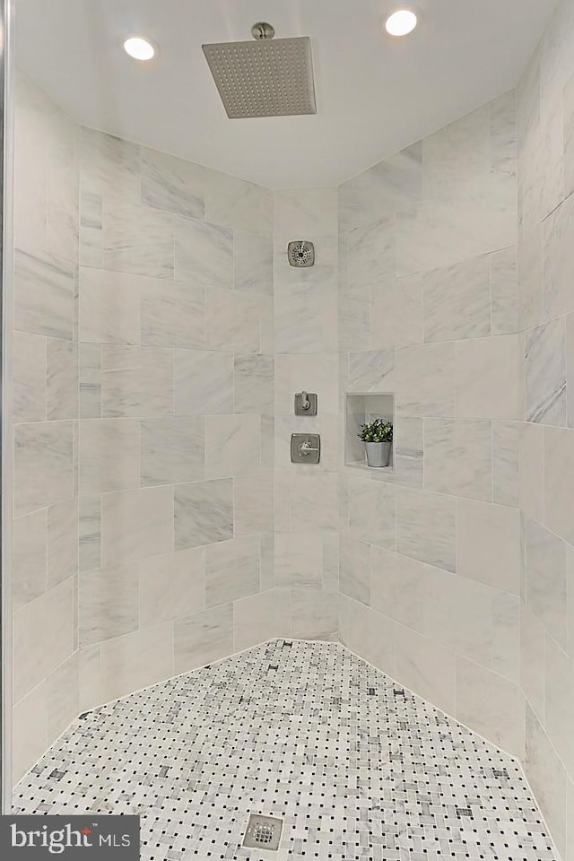 bathroom with a tile shower