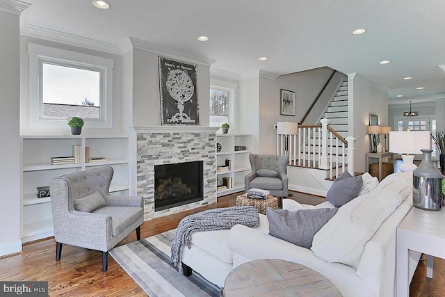 living room with hardwood / wood-style floors, plenty of natural light, and ornamental molding